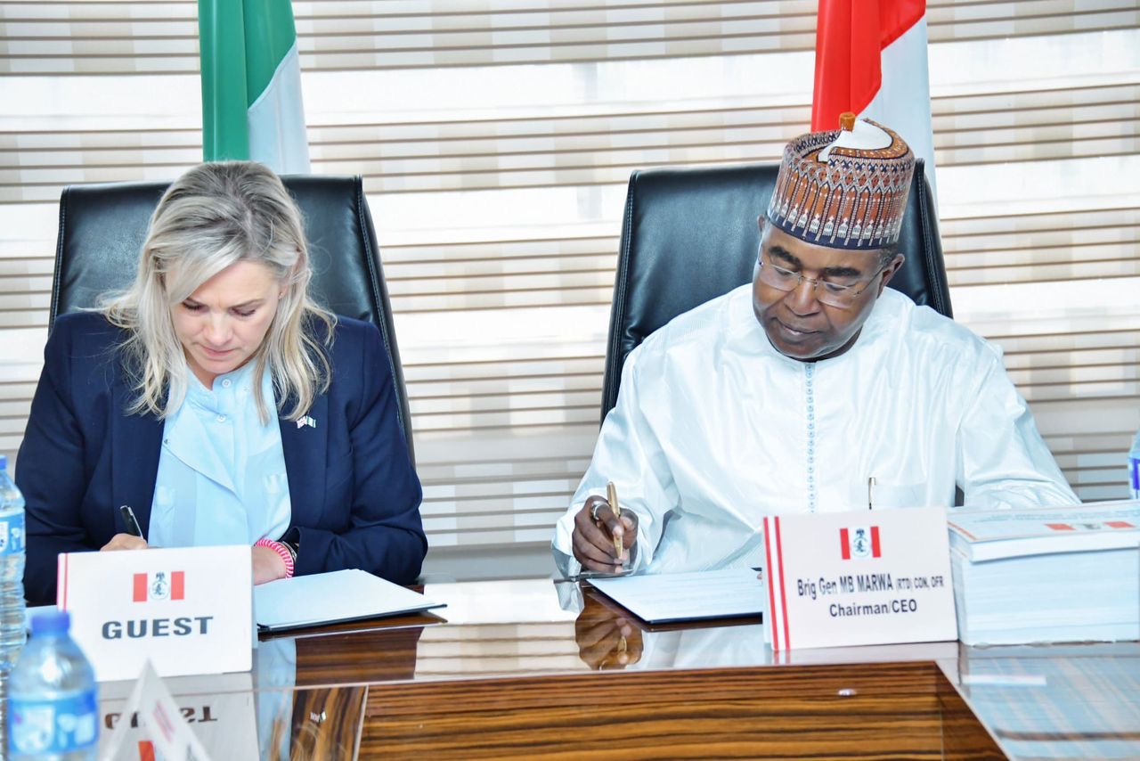 Victoria Pullen of United Kingdom Home Office International Operations and Brig Gen Buba Marwa of NDLEA signing documents as UK renews partnership with Nigeria on drug war.